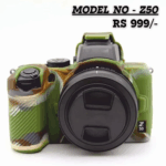 A Nikon Z50 mirrorless camera covered in a custom silicone protective case featuring a green, brown, and tan military camouflage pattern. The lens cap is on, and the camera is shown against a white background. Text overlay reads: "MODEL NO - Z50 RS 999/-".